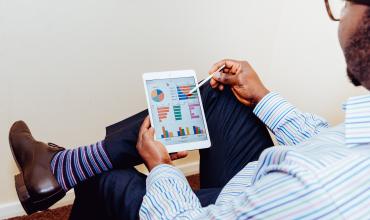 Common Home Buying Scams and How to Avoid Them A man sitting and using a tablet