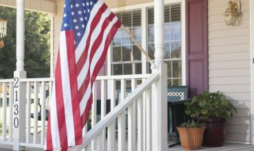 an American flag on a front porch