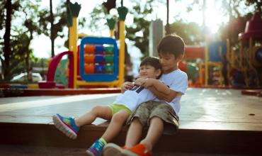 graphic with two children on a playground