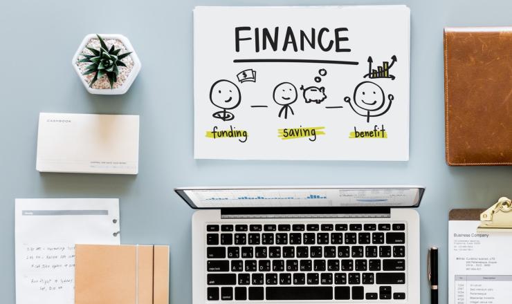 a computer, calculator and financial papers