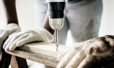 construction worker using a power drill