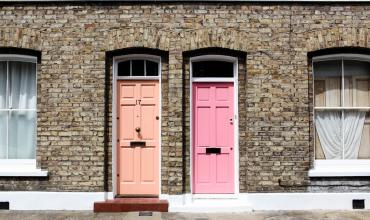 a coral door and a pink door side by side