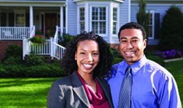 Couple in front of home