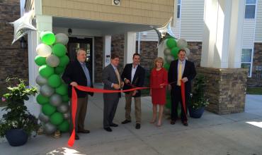 ribbon-cutting dedication for the apartments with residents