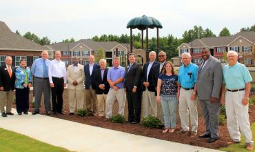 a group of people standing outside Enfield Commons apartments