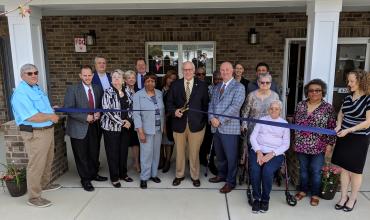 Grand Opening Celebration Held April 8 for Shepard Greene in Zebulon ribbon cutting in front of shepard greene