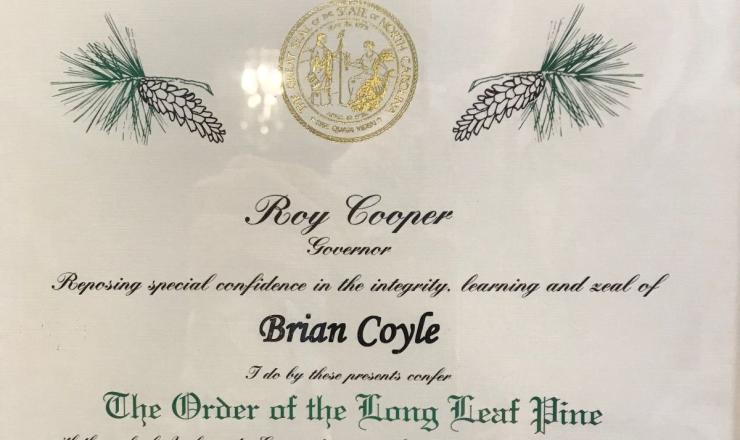 NC Housing Partnership Chair Brian Coyle Awarded Order of the Long Leaf Pine A photo of the award