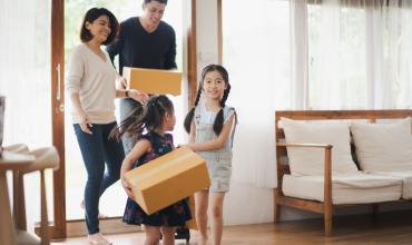More North Carolinians Now Eligible for Affordable Mortgages and $15K Down Payment Assistance A family walking into their new home with boxes