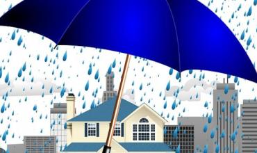 Vector image of a house being covered from rain by a big blue umbrella