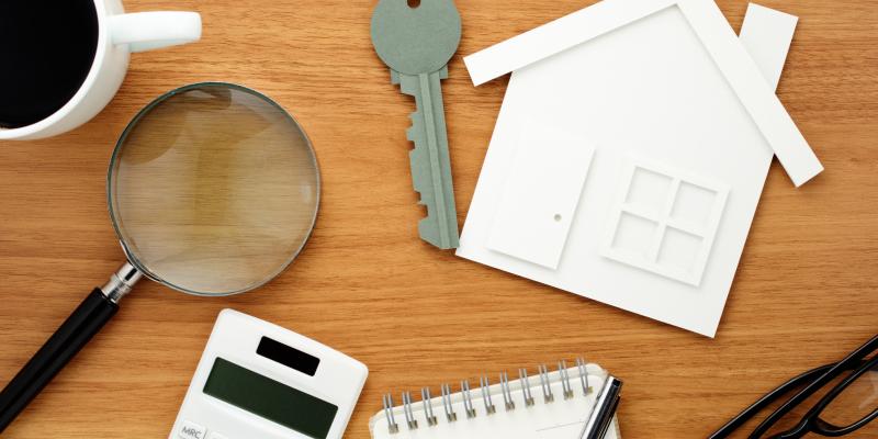 house, calculator and keys on a table