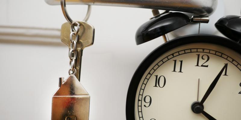 A clock, a key and a door handle