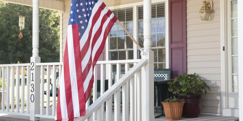 an American flag on a front porch