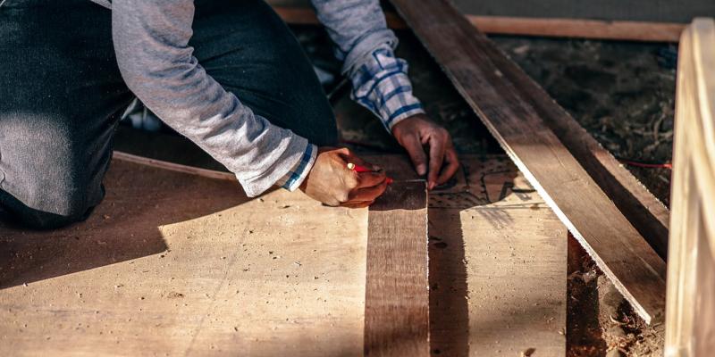 a man measuring wood