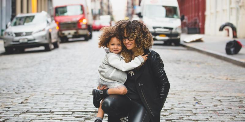 child and woman hugging