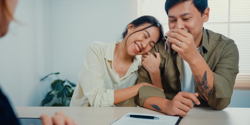What to Know About an HOA A happy couple sitting at a desk