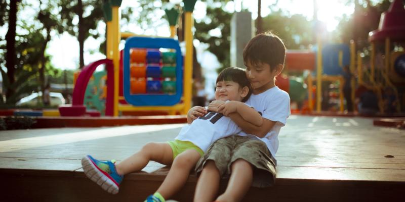 graphic with two children on a playground