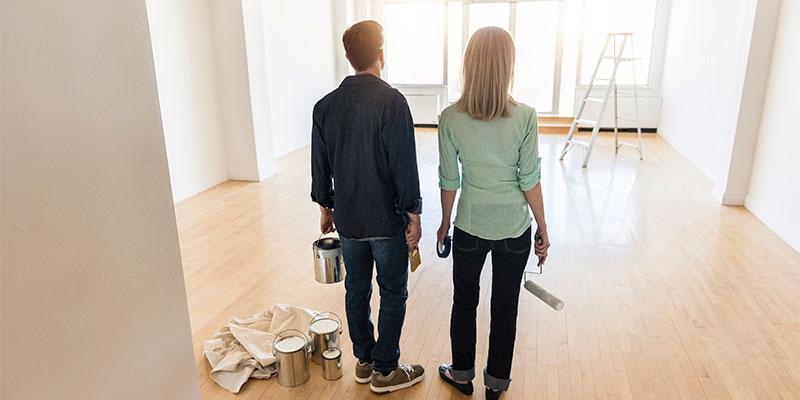 a couple standing and admiring the inside of their new home