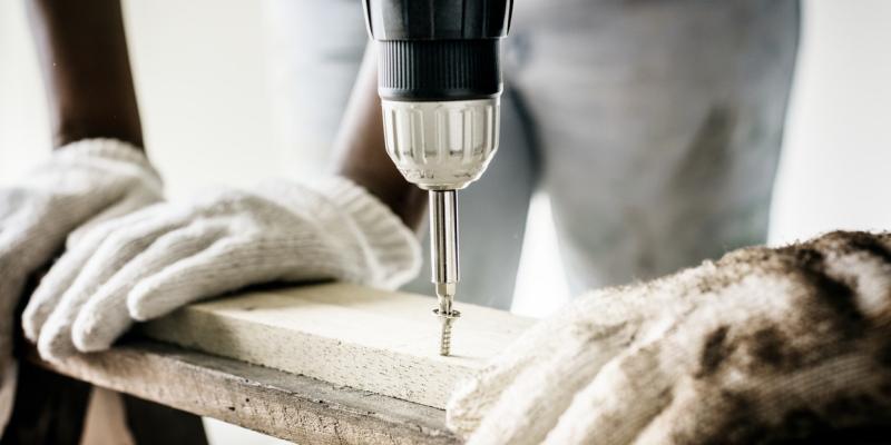 A worker using a power drill