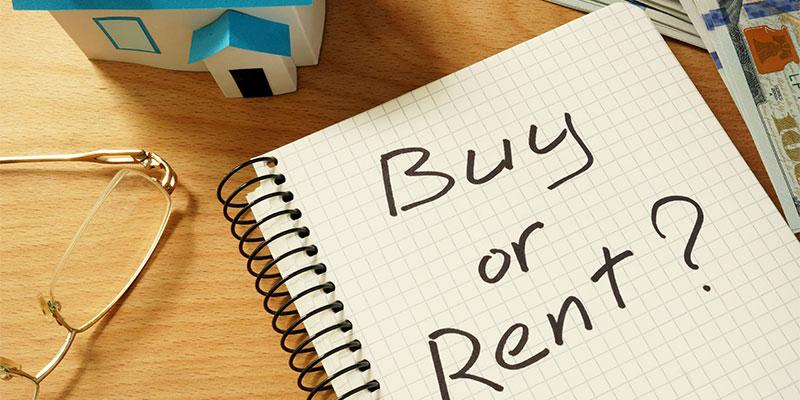 Renting v. Buying: Which is Right for You? a notebook with buying vs. renting written on it