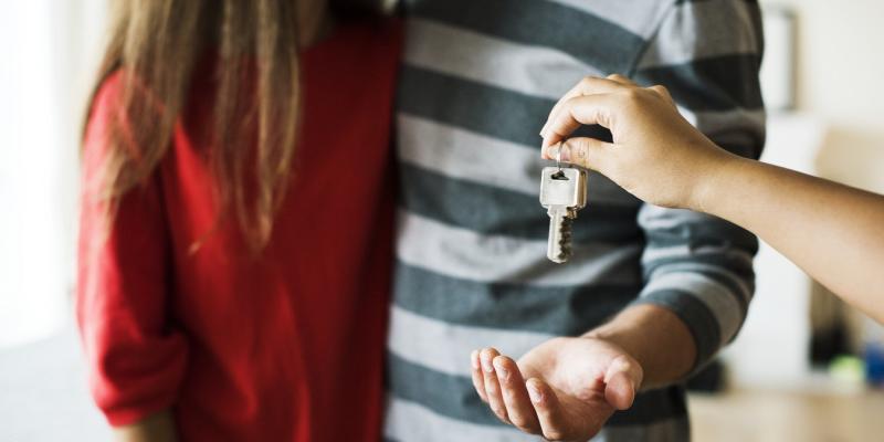 a couple being handed a house key