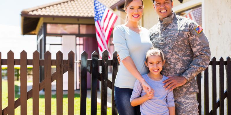 How to Buy a Home as a Military Veteran A military family standing in front of their home