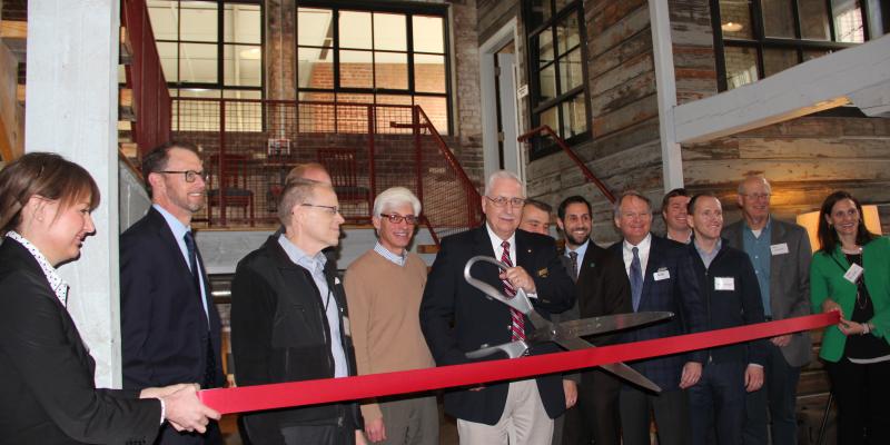 people lining up to cut the ribbon