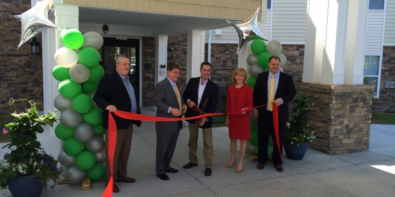 ribbon-cutting dedication for the apartments with residents