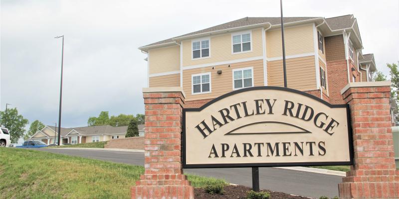 Photo of Hartley Ridge Apartments sign with building in the background