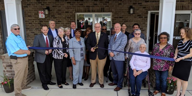 ribbon cutting in front of shepard greene