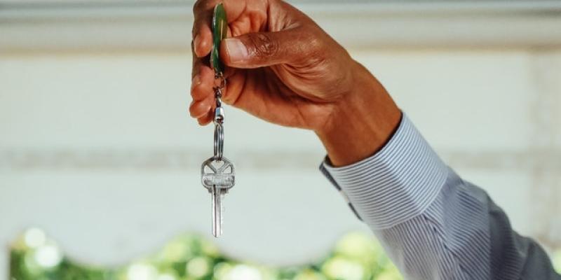 Hand holding a house key